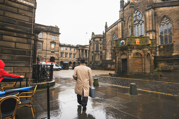 Edinburgh street photography captures the charm of the city on a rainy day. Colorful umbrellas, historic architecture, locals going about their day. A perfect representation of Scotland's capital city
