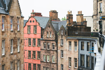 Rainy streets of Edinburgh come alive with locals braving the weather. Edinburgh's Old Town shines on a rainy day. Raindrops cling to windowpanes, reflections of Edinburgh's historic buildings