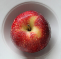 beautiful red apple in a white plate, background