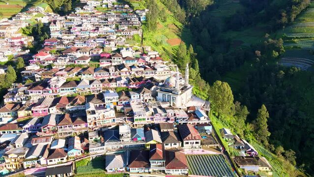 Drone shot of Beautiful rural landscape and mosque with 2 minarets located on the slope of Mount Sumbing, Indonesia - Baituttaqwa mosque on Nepal Van Java, Indonesia