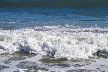 Striking scene of waves breaking on the sand of a Spanish beach