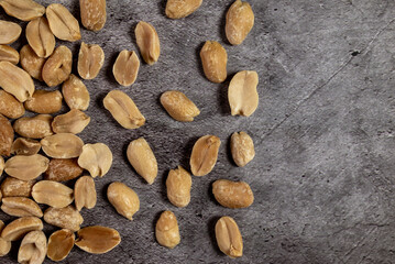 Roasted peanuts on a slate table. Dried fruits and healthy food, top view.