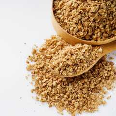 fresh raw buckwheat flakes on a white background