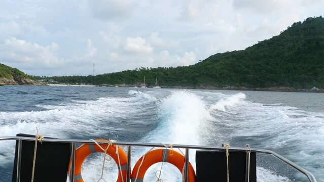 Waves on sea, splash, spray from speedboat. Scenic view of sea waves splashing against blue sky. Tourism and travel concept
