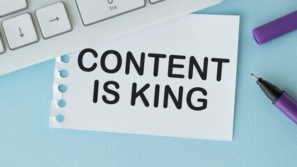 Paper written CONTENT IS KING on Blue desk with keyboard