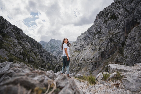 Cheerful woman enjoying freedom in mountains