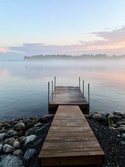 Tender fog at the lake, bright blue and purple sky, natural misty lake background