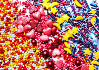 Fototapeta na wymiar Background with a lot of delicious decorations in the form of colorful beads. Confectionery. Sweets