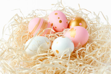 Happy Easter concept. Colorful decorated easter eggs on an isolated white background. Fancy Easter pastel colored eggs in nest