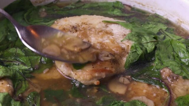 Turkey fillet cooking chop in sauce with green leaves