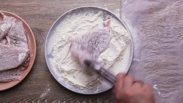 Cooking Pork chop roll in flour, fry