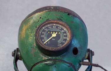 The old motorcycle headlight with speedometer, close-up view. © milkovasa