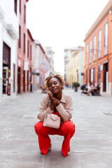 Fashion woman in red walking on a city street