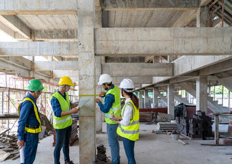 Teamwork of civil technician engineers and professional architects working together to inspect and...