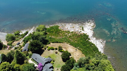Aerial view of the shore of a lake during the summer season.