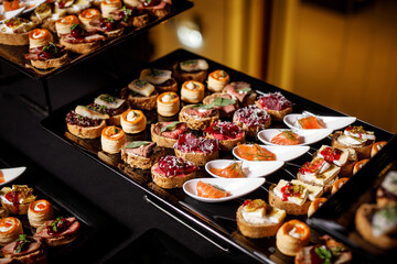 Catering plate. Assortment of snacks on the buffet table.