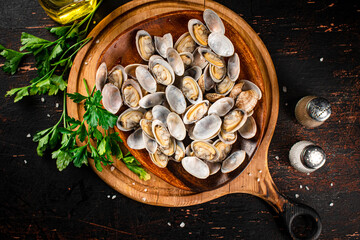 Vongole on a wooden plate with parsley. 