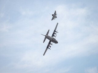 Fighter jet escorting plane