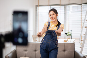 Asian young beautiful woman streamer listening to music dancing and listening music at Home...