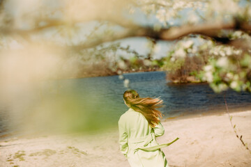 stylish woman green coat background spring flowering