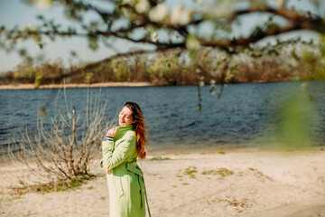 stylish woman green coat background spring flowering