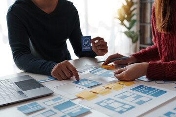 Designers, programmers, and mobile application developers work together to innovate modern and...