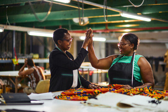 Mature African Business Woman Sewing Factory With Employee