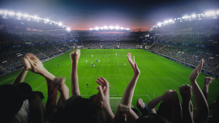 Establishing Shot of Fans Cheer for Their Favorite Team on a Stadium During Soccer Championship Final Match. Teams Play, Crowd of Fans Celebrate Victory and Goal. Football Cup Tournament.