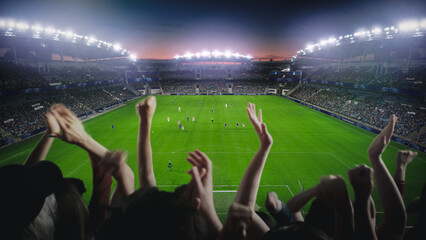 Establishing Shot of Fans Cheer for Their Favorite Team on a Stadium During Soccer Championship...