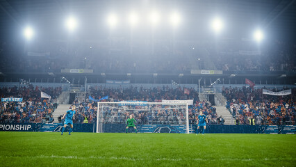 Football Championship: Blue Team Players and Goalkeeper are Defending the Goals. Closely Paying Attention to Opponents Moves, Focused and Ready to Counterattack. Crowd of Fans Cheers.