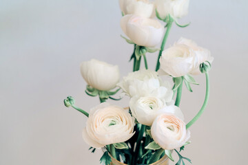 Obraz na płótnie Canvas Bouquet with white ranunculus in vase close up