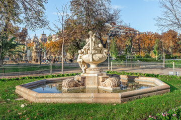 Fountain Font dels Nens by Josep Reynes i Gurgui, 1893, in Parc de la Ciutadella in Barcelona, Spain. Ancient Vase with children or Gerro amb nens sculpture inside the water pool on a sunny autumn day