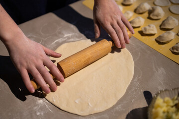 Sculpt dumplings. Make dumplings in the kitchen. Dough for dumplings. Ukrainian traditional dish....