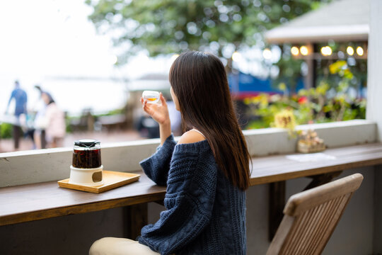 Woman enjoy the tea at outdoor cafe