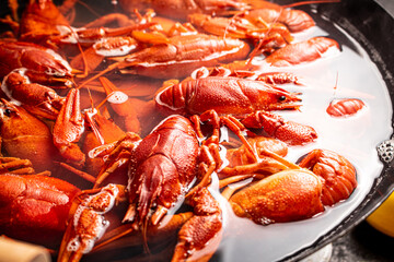 Crayfish are boiled in a pot in water. 