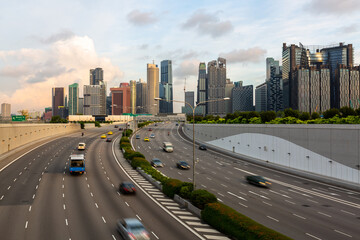 Singapore city highway traffic in city at morning, Road to Singapore downtown with business financial landmark buildings in Singapore skyline and skyscraper. - obrazy, fototapety, plakaty