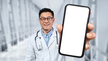 Happy Asian Doctor Holding Big Blank Smartphone With White Screen In Hand