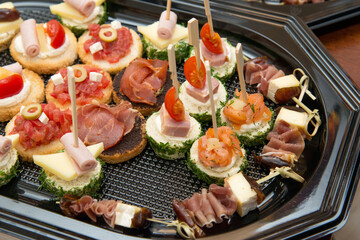 The buffet at the reception. Assortment of canapes. Banquet service. Catering, snacks with different types of cheese and meat. Party Concept.