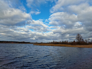 lake in winter with beautiful clouds in the blue sky