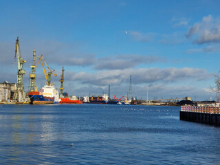 Gdansk on a sunny day. Big cranes and dock at the shipyard. city is located right by the sea....