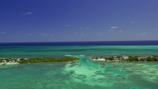 Drone shot over the split lagoon, revealing resorts and buildings, at the Caye Caulker island, Belize, Central America 