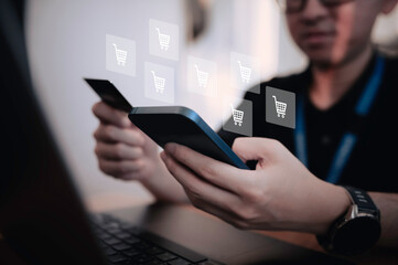 Hand of asian man holding smartphone with credit card,Pay for various bills that use a credit card