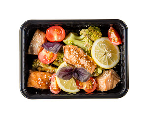 A dish in a black disposable container from catering on a concrete background, dietary catering,...