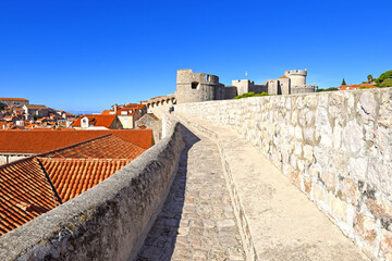 Walk on the ancient, defensive city wall in Dubrovnik, Croatia at the Dalmatian Coast of the Adriatic Sea - obrazy, fototapety, plakaty