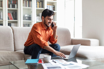 Wealthy arab businessman working from home, using laptop