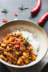 Chili Con Carne in bowl on dark background. Mexican cuisine. chili con carne - minced meat and vegetables stew in tomato sauce. Top view