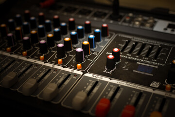 Sound mixer. Professional audio mixing console with lights, buttons, faders and sliders.