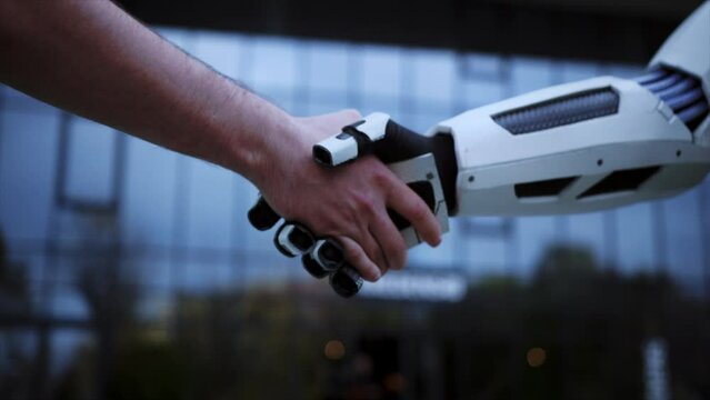 Horizontal footage of robot handshaking human hand. Social concept. Development of modern technologies. Agreement between human and artificial intelligence