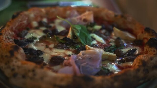 Pizza capricciosa. Pizza with ham, olives, mushrooms and artichokes.