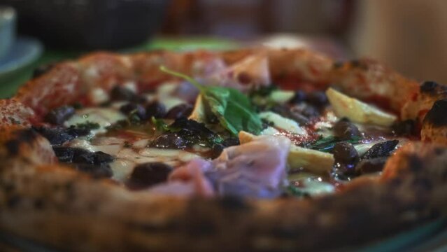 Pizza capricciosa. Pizza with ham, olives, mushrooms and artichokes.